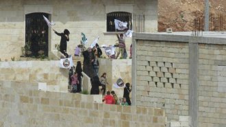People in Maarat an-Numan protest against Jabhat an-Nusra from within a Division 13 base (March 14, 2016)